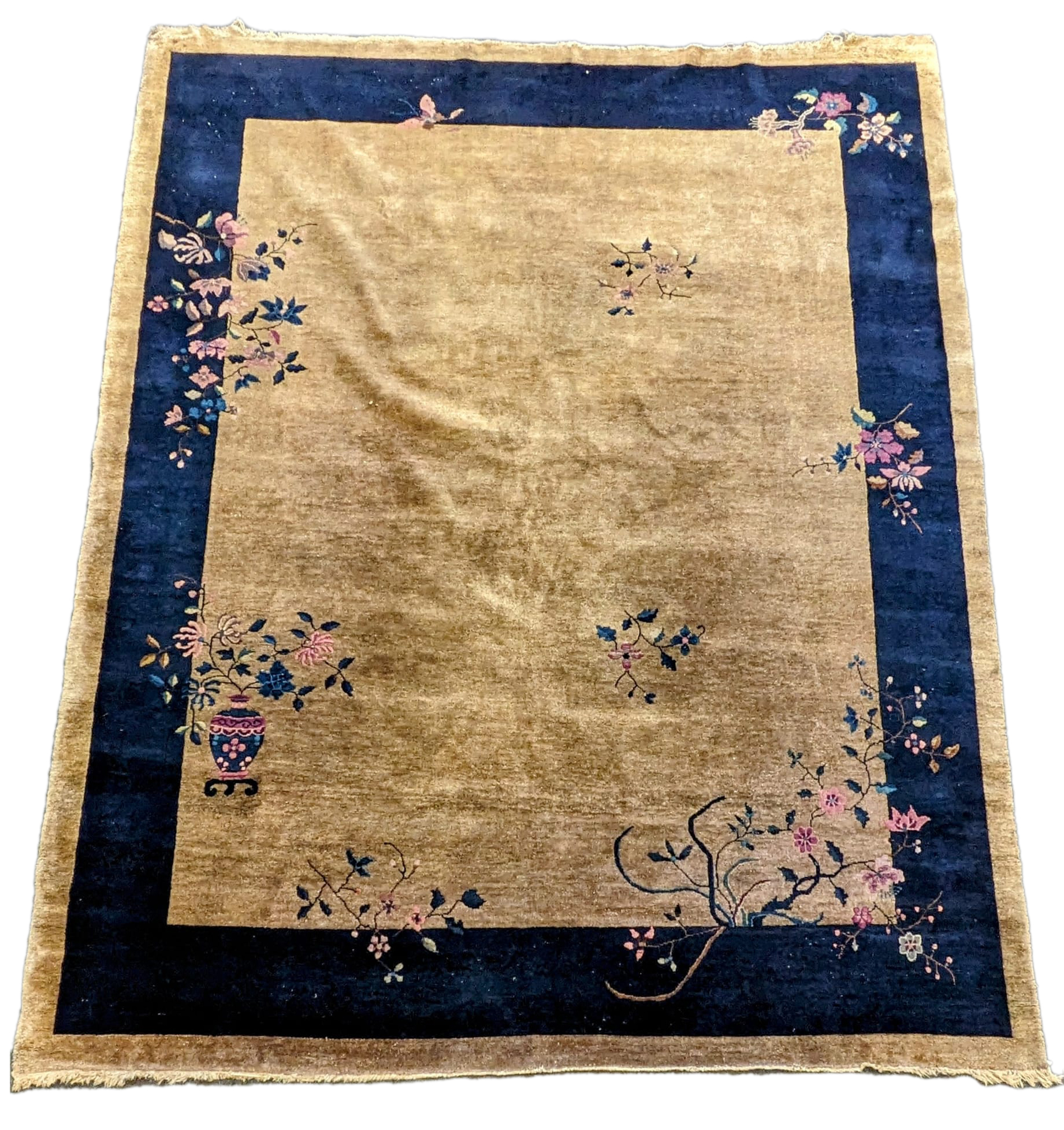 A Walter Nichols Chinese champagne ground carpet with asymmetrical decoration of flowers and an urn, single dark blue border, 350 x 280cm. Condition - fair